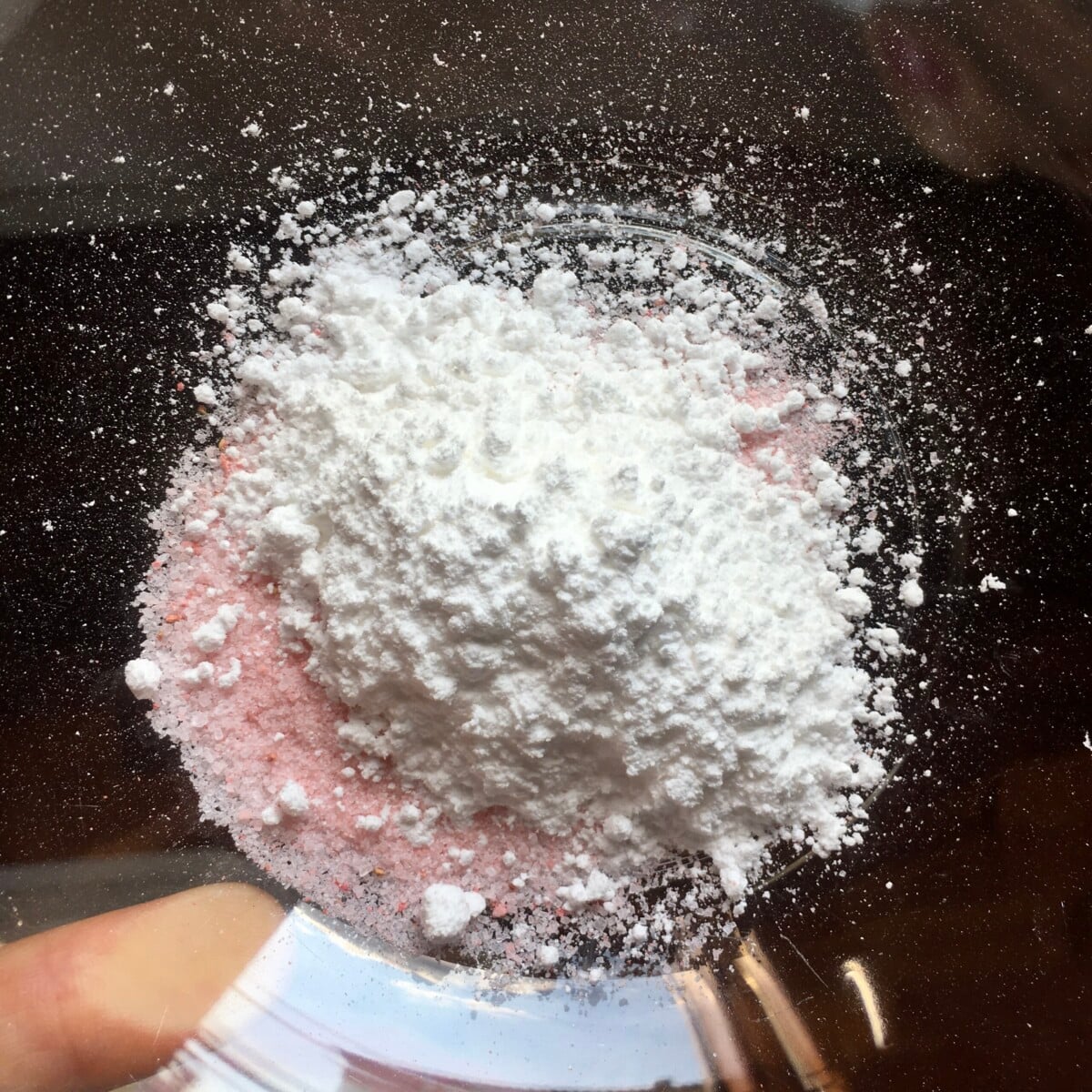 Powdered sugar and regular strawberry sugar combined in a bowl.