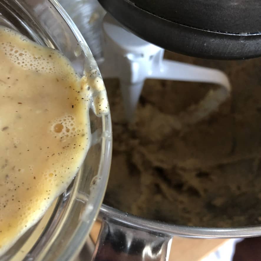 adding egg to the cookie creamed butter and sugar