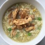 a small bowl of egg drop soup with crispy fried homemade wonton strips.