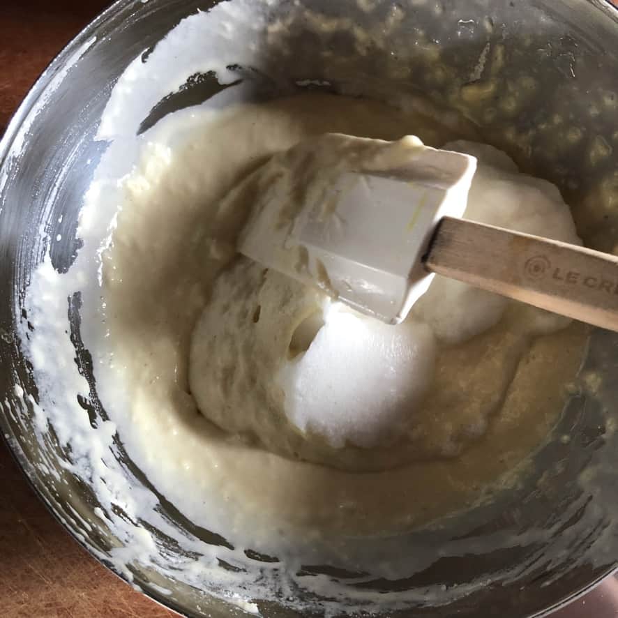folding a whipped egg white into the pancake batter