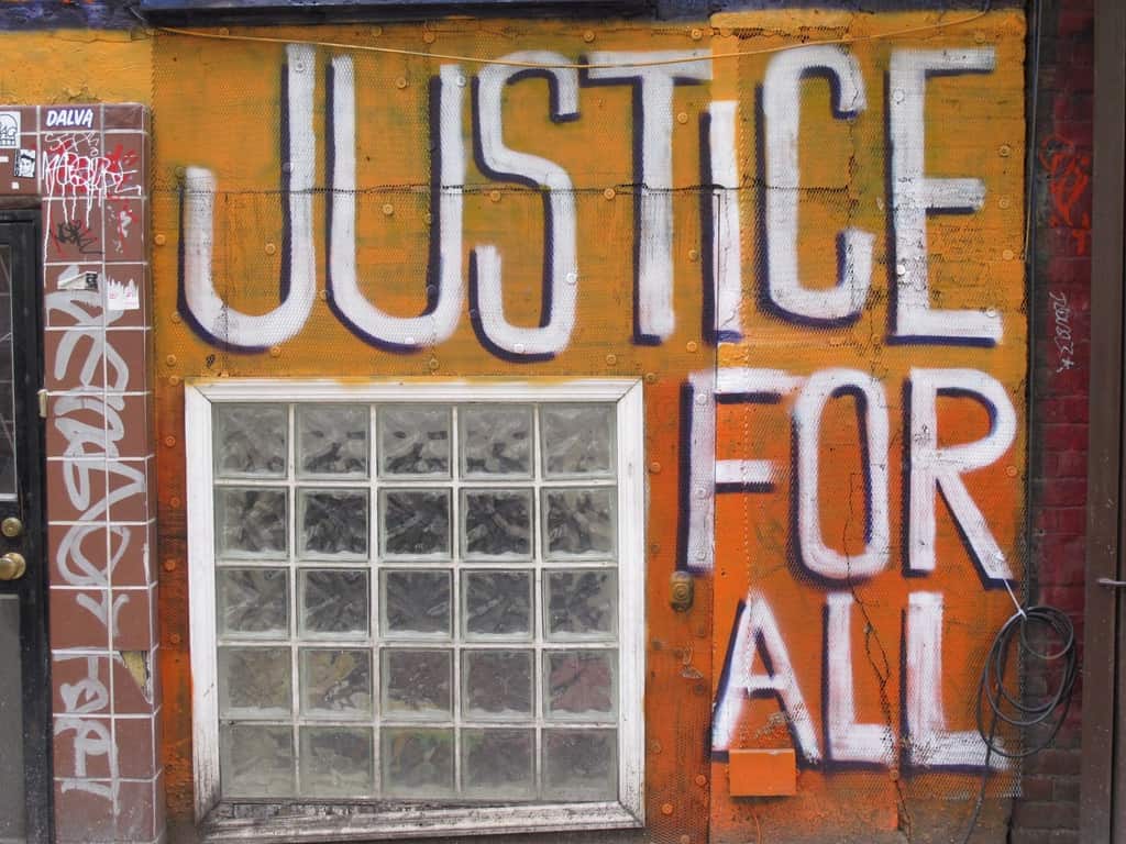 a portion of wall graffiti in NYC that says "JUSTICE FOR ALL""