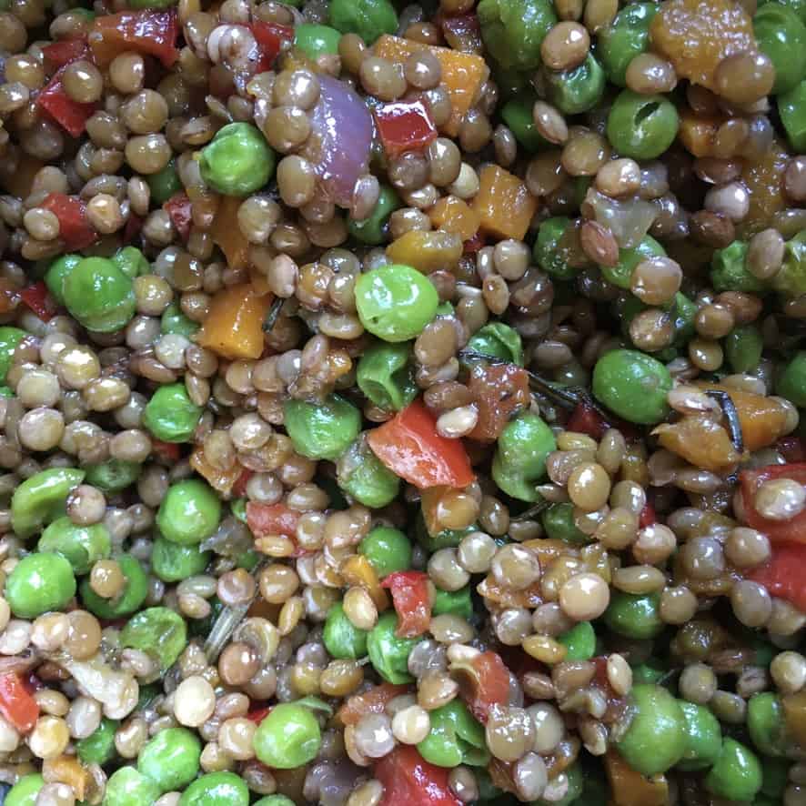 farro grain salad with diced red bell peppers, pan-seared carrots, onions and green peas