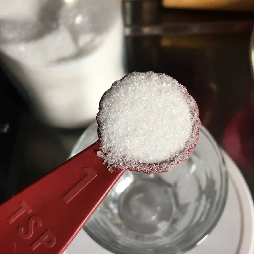 a tablespoon of sugar in a red Nordic Ware bundt pan shaped measuring spoon