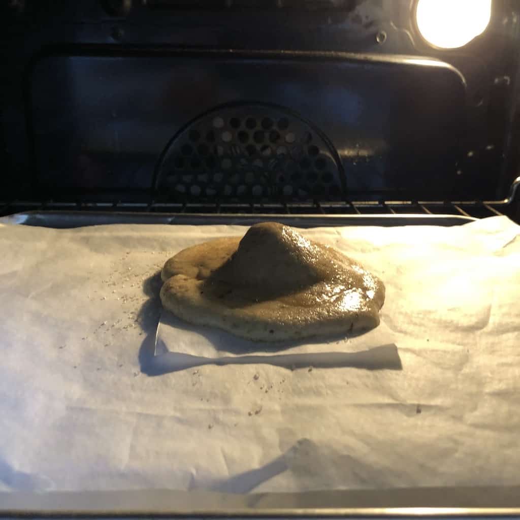 a cookie as it bakes starting to puff up