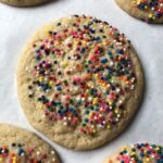 a beautiful and perfectly cooked sugar cookie covered with nonpareils
