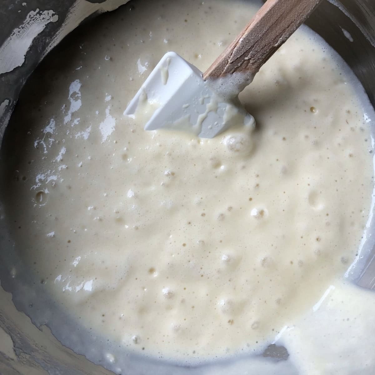 Perfect fluffy buttermilk pancake batter with lumps, no flour streaks, and folded whipped egg whites showing the ideal pancake batter consistency.