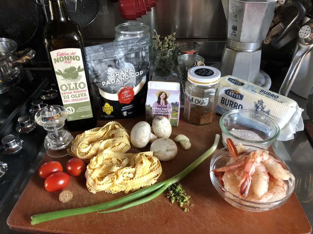 Shrimp fettuccine Alfredo ingredients on aa cutting board
