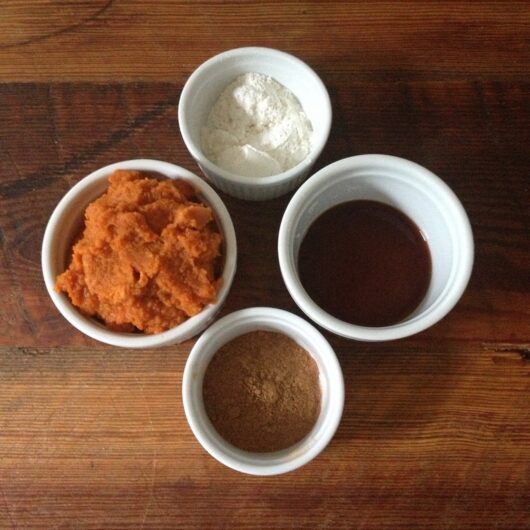 canned pumpkin, vanilla extract, salt, and pumpkin pie spice in white ceramic ramekins on a table