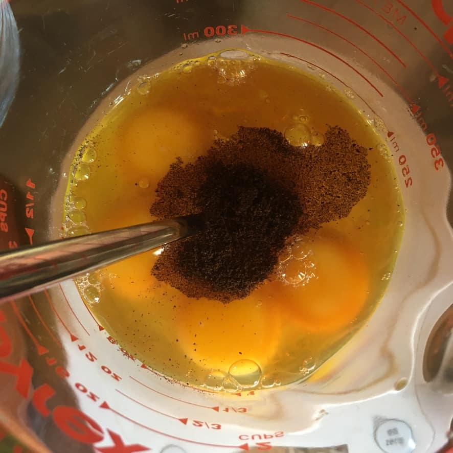 whole eggs, vanilla bean, vanilla extract and salt in a glass measuring cup