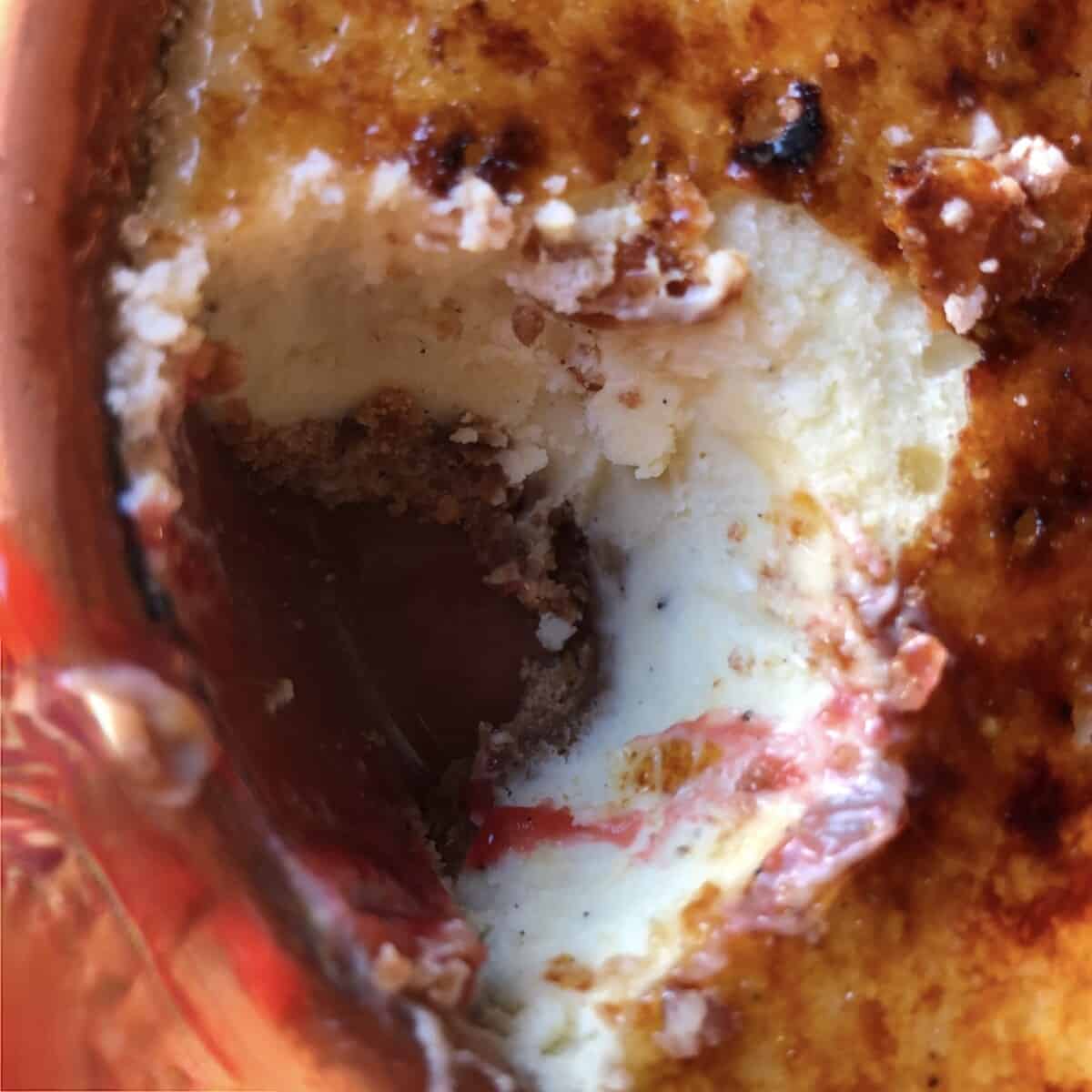 a missing hole where the cheesecake has been removed and eaten revealing the vanilla bean speckled white cheesecake and Biscoff crust