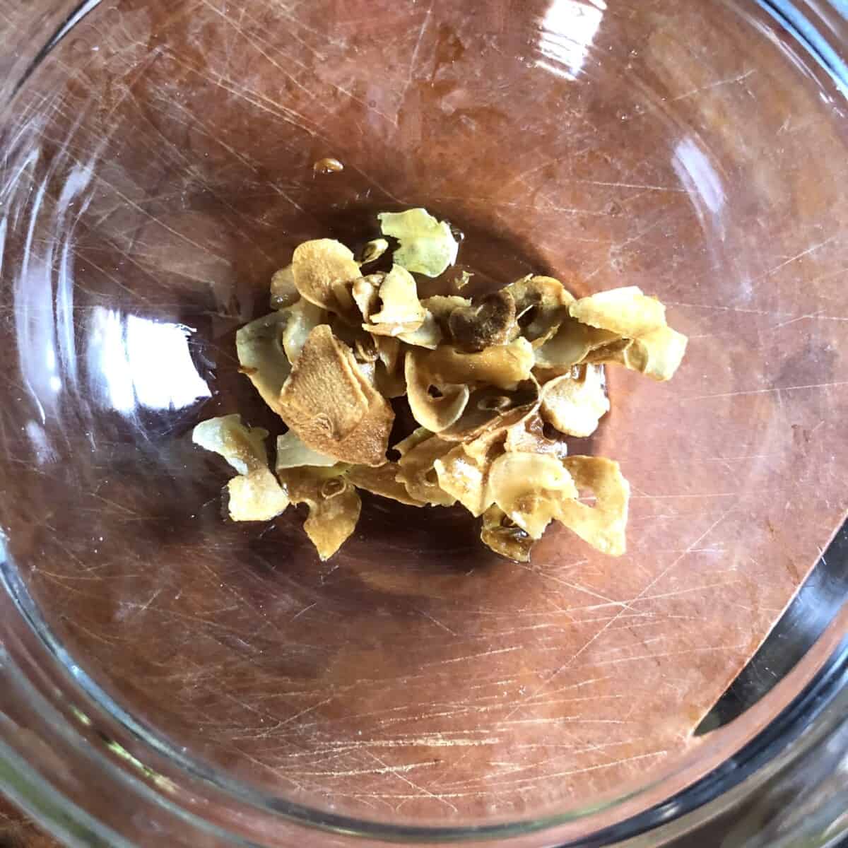 fried golden brown garlic in a bowl