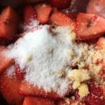 white sugar and blood orange sugar in a pot with strawberries