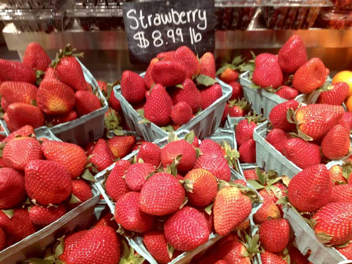 strawberries for sell in the ubiquitous blue-green quart-sized paper 'flats" lined up nicely in the market at Grand Central Station, NYC