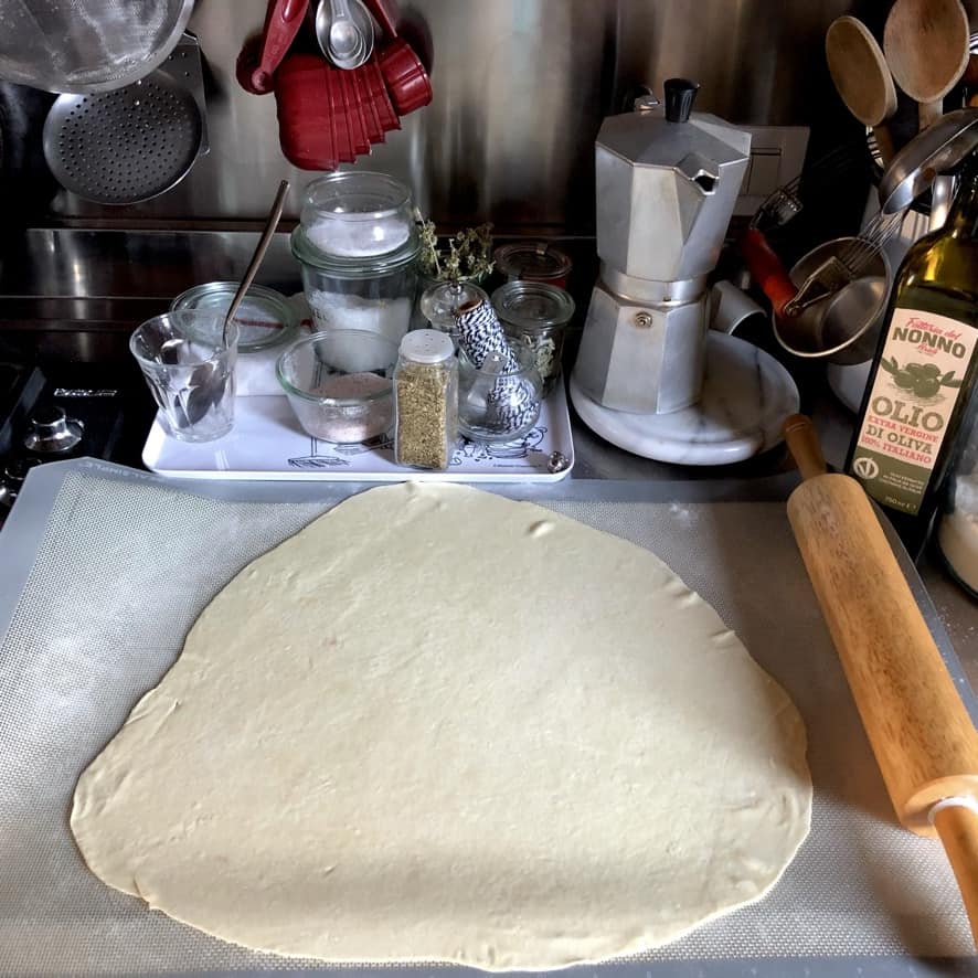 all-purpose flour used for St. Louis Style Pizza dough rolled out on a non-stick baking/rolling mat