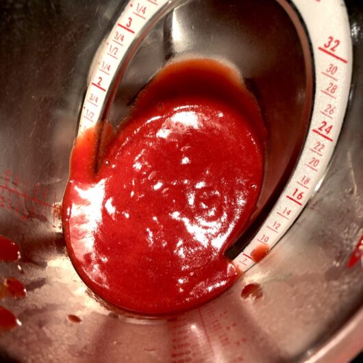 final strained strawberry coulis in an OXO 4 cup measuring cup