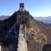 a view of the deteriorating walls and pathways on the Jinshanling section of the Great Wall of China with steep dropoffs