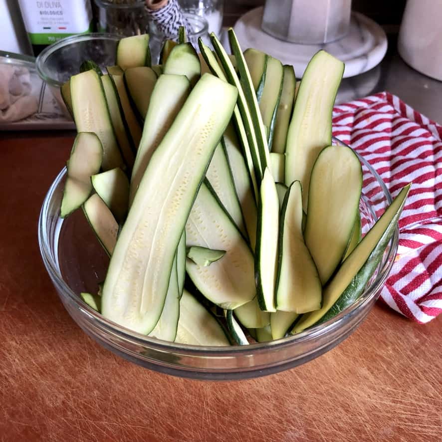 long thinly sliced zucchini in a bowl