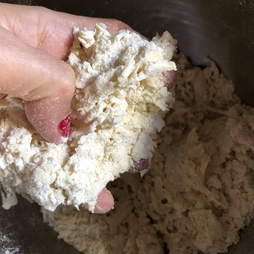 my hand holding a mound of eggy flour mixture