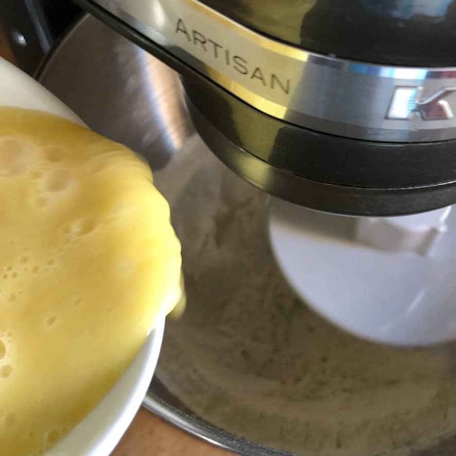 beaten eggs being added to a Kitchen Aid mixer
