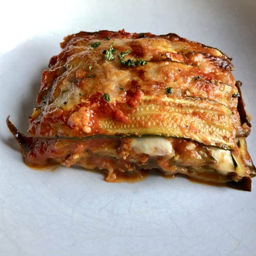 a large square of vegetarian parmigiana on a plate