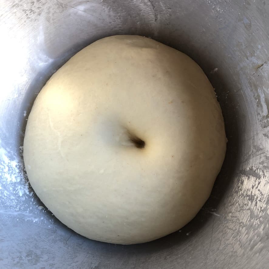 wonton dough after being properly kneaded (totally soft and smooth) with a finger indentation that looks like a belly button right in the middle