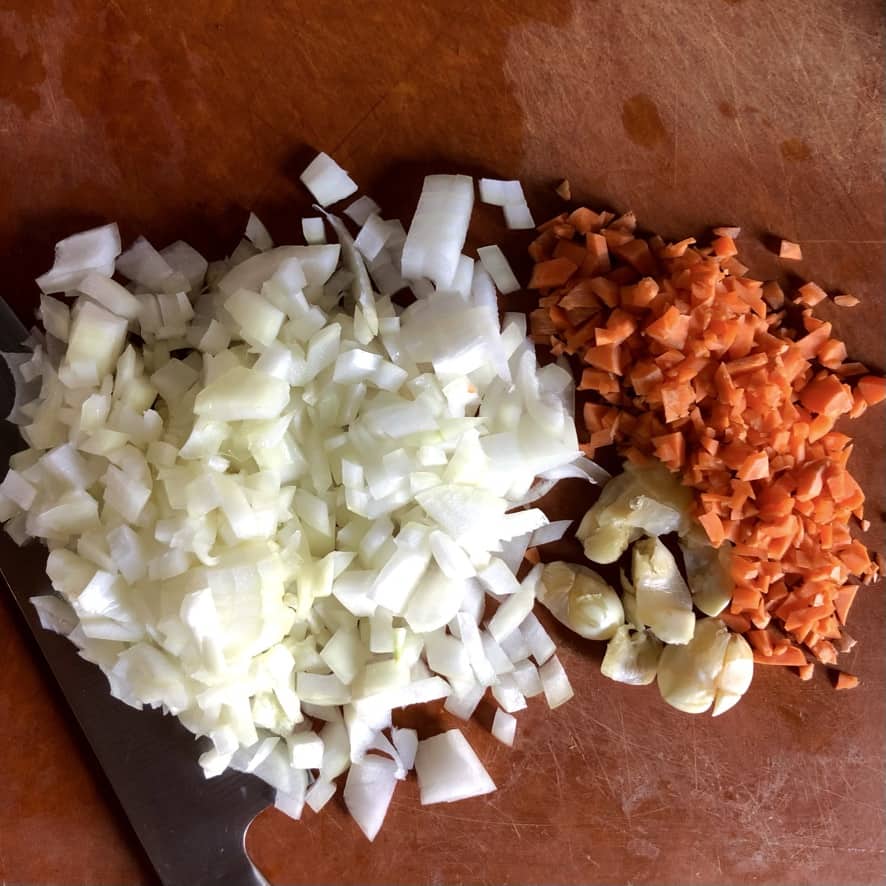 chopped onions, carrots and smashed garlic cloves