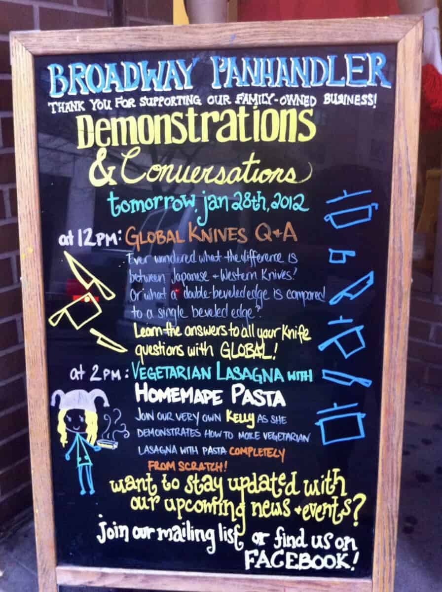 The sandwich board outside of the entrance at The Broadway Panhandler store in NYC, showing an illustration of kelly and the homemade pasta cooking demo she was conducting that day using a KitchenAid Mixer with Pasta Attachment.