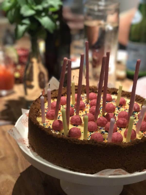 Happy Birthday Cheesecake with pokki sticks on a table