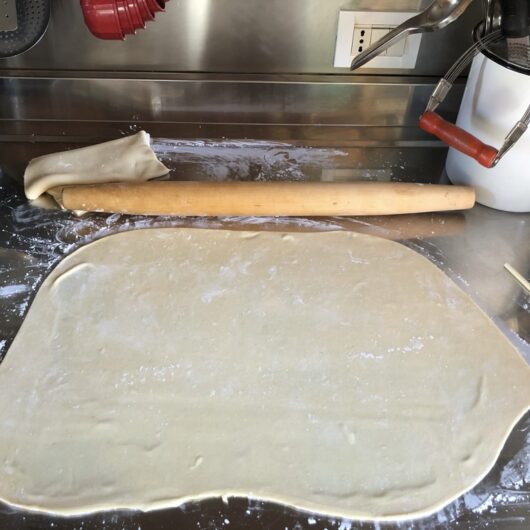 homemade wonton dough being rolled out