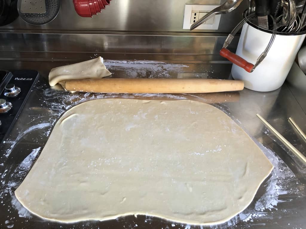 homemade wonton dough being rolled out