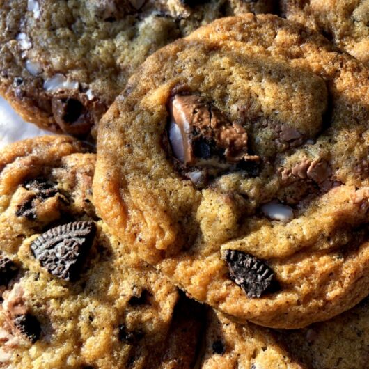 beautiful shot of the cookies piled on top of each other slightly and the sun shining in through the window on them making them look even more golden
