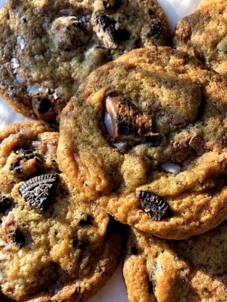 beautiful shot of the cookies piled on top of each other slightly and the sun shining in through the window on them making them look even more golden