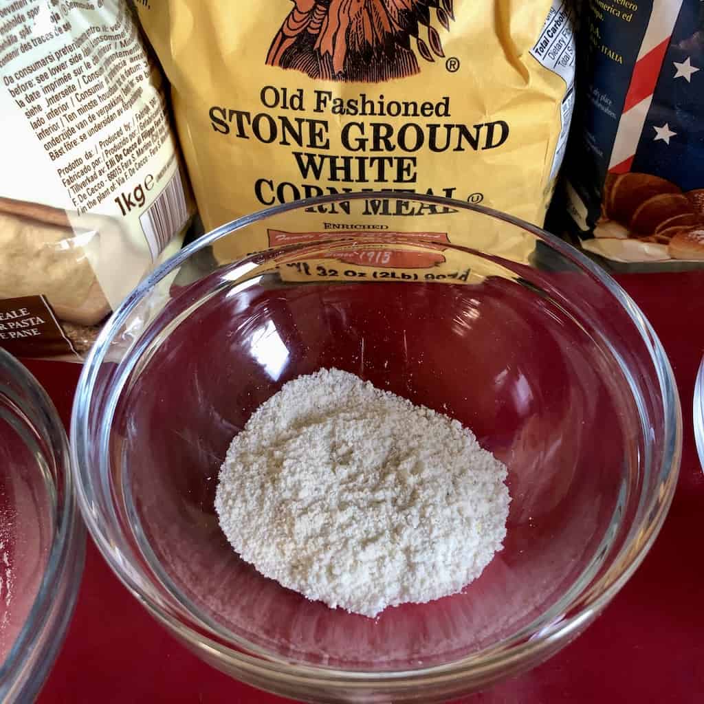 cornmeal in a prep bowl in front of the bag of white stone ground cornmeal