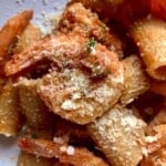 Creamy Argentinian shrimp pasta with rigatoni in tomato cream sauce alfredo topped with grated Grana Padano parmesan cheese, creamy shrimp pasta recipe.