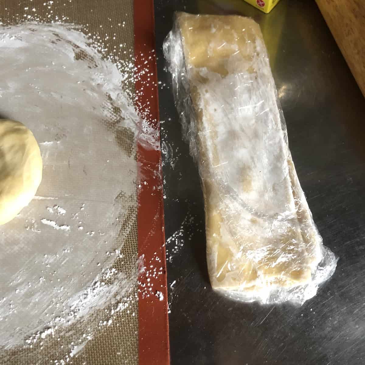Wonton wrapper dough individually wrapped in sustainable cling film resting before the final roll, homemade wonton wrappers resting step.
