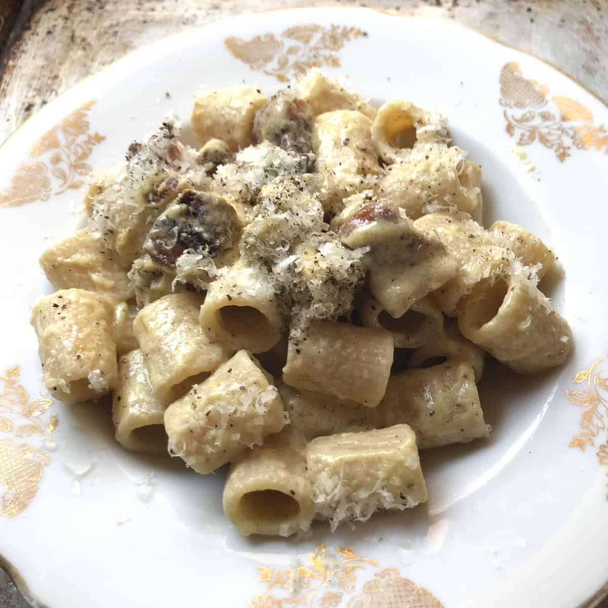 Rigatoni alla carbonara with guanciale, pecorino romano cheese and black pepper, traditional carbonara recipe.