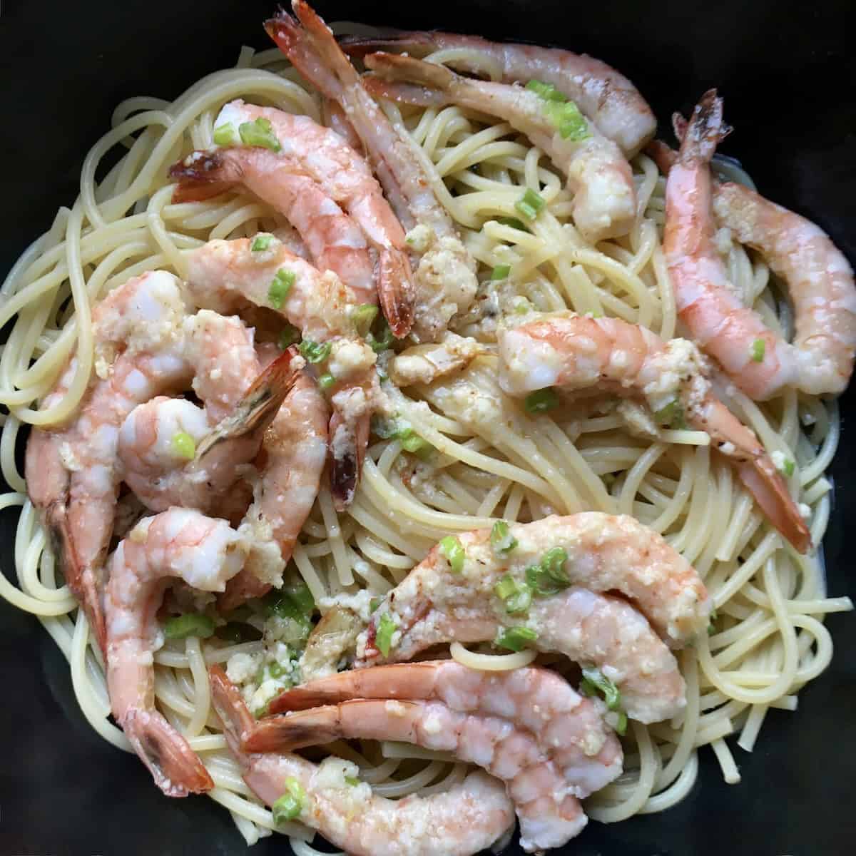 Shrimp scampi pasta in serving dish ready to eat with garlic butter shrimp, shrimp scampi pasta recipe.