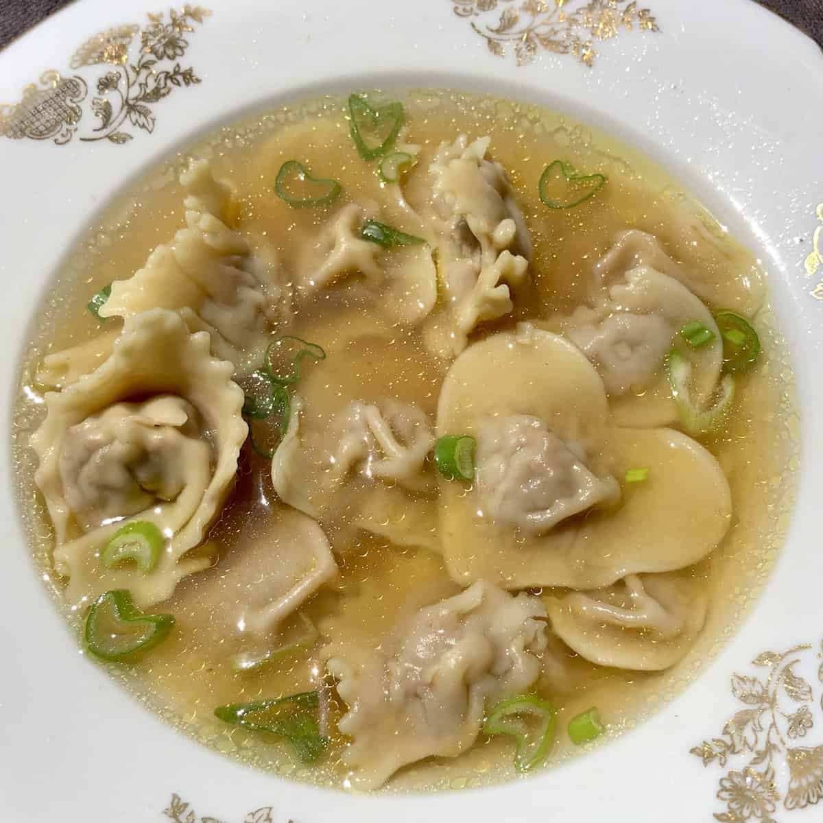Homemade Sichuan pork and ginger wontons shaped into hearts including full hearts and broken hearts in homemade broth, pork wonton recipe.