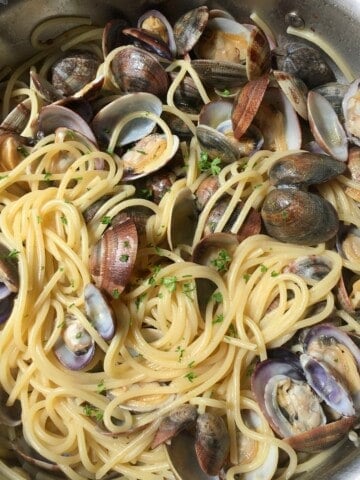 Spaghetti alle vongole with veraci clams in All-Clad saute pan, best clam pasta recipe with fresh Italian clams.