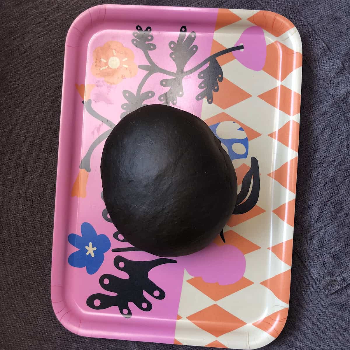 Homemade squid ink pasta dough showing intense black color for making fresh squid ink pasta recipe.