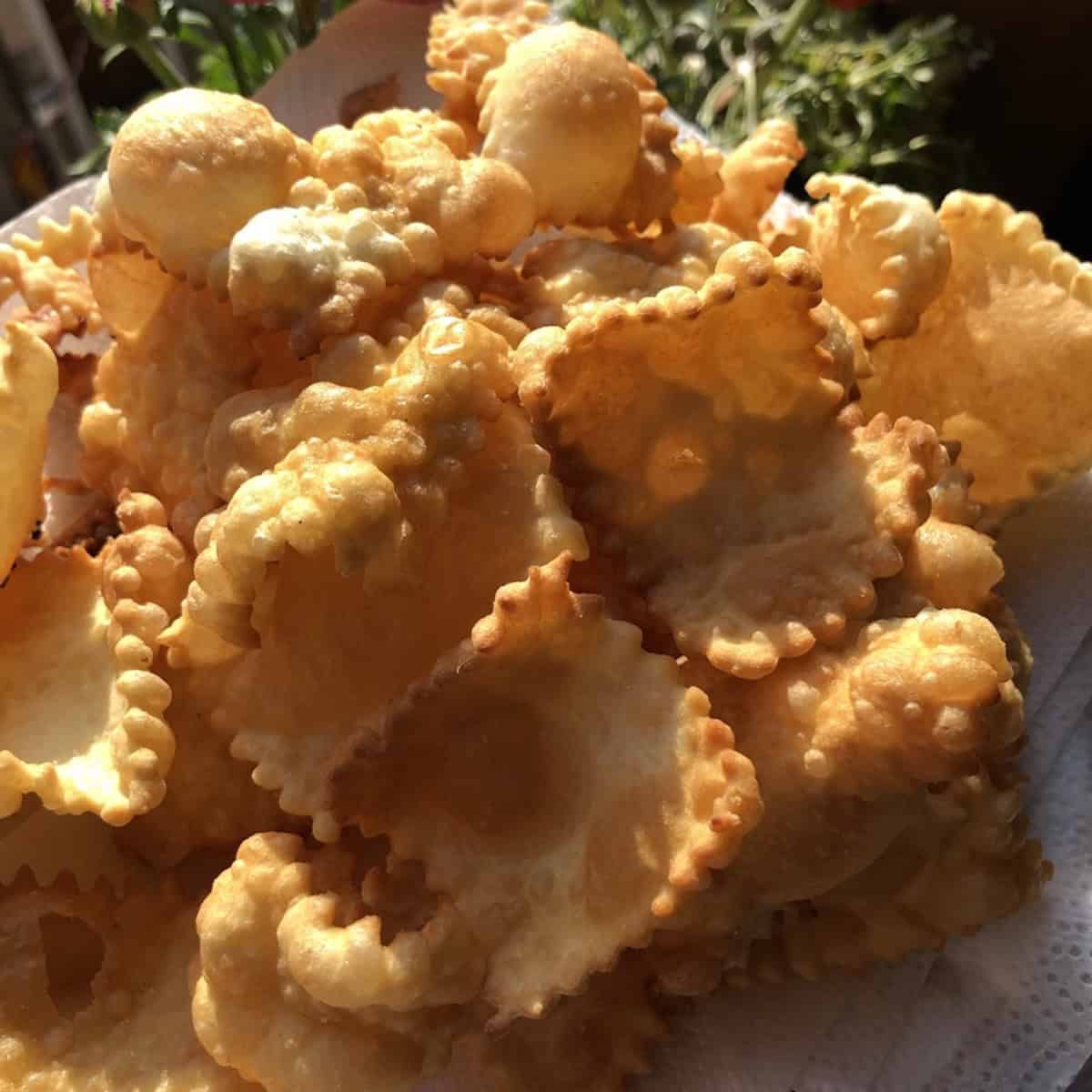 A platter of homemade crispy golden brown bubbly fried wonton chips, wonton chips made with homemade wonton wrappers for a crunchy appetizer.
