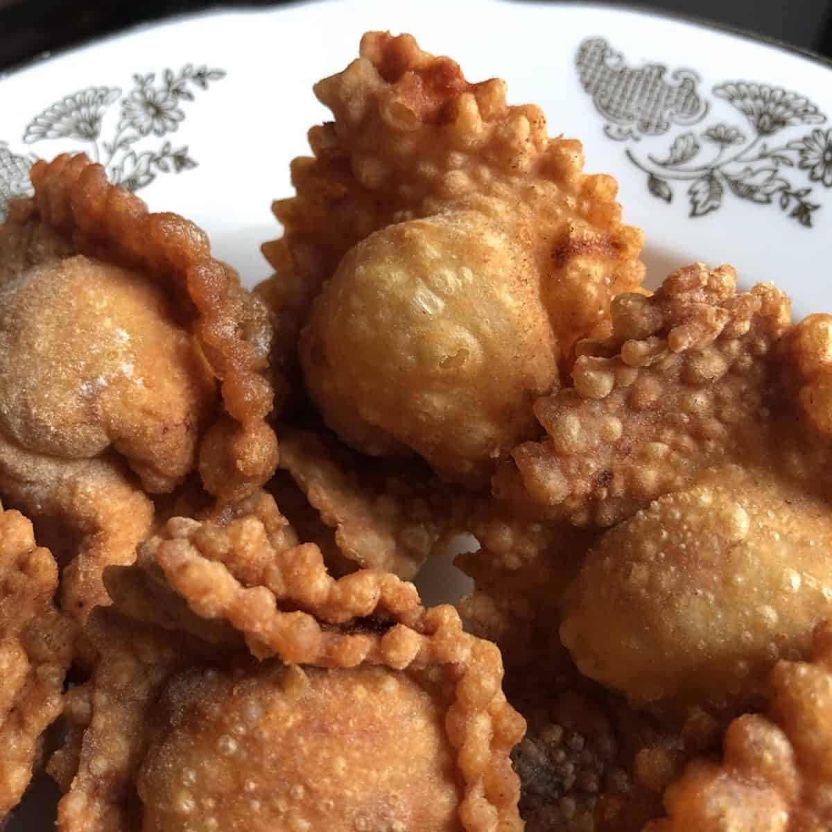 A pile of crispy golden brown fried wontons made with homemade wonton wrappers.
