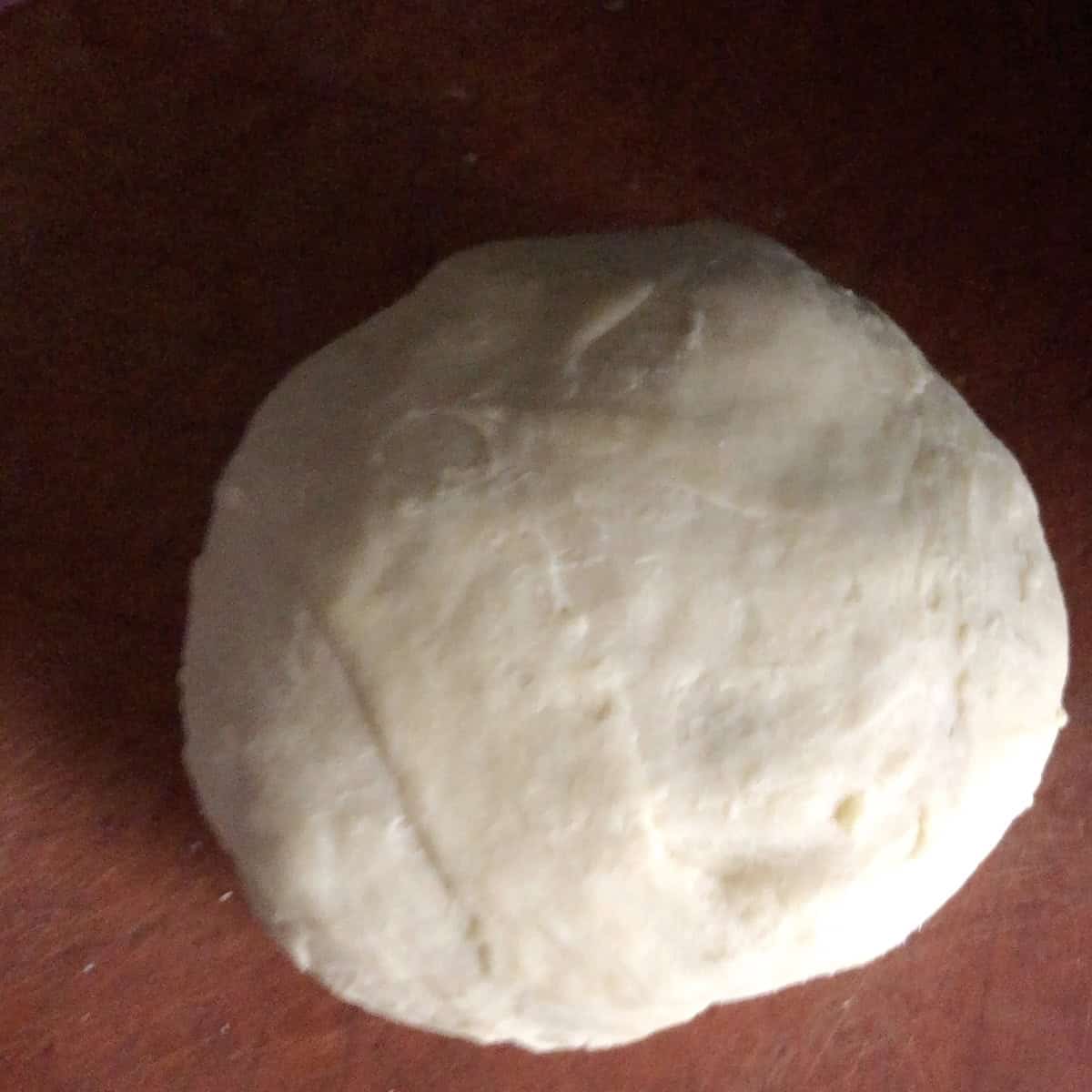 
Fairly smooth kneaded wonton wrapper dough ready to be covered and rested for 30 minutes to an hour to relax the gluten, wonton dough recipe step before rolling and cutting.
