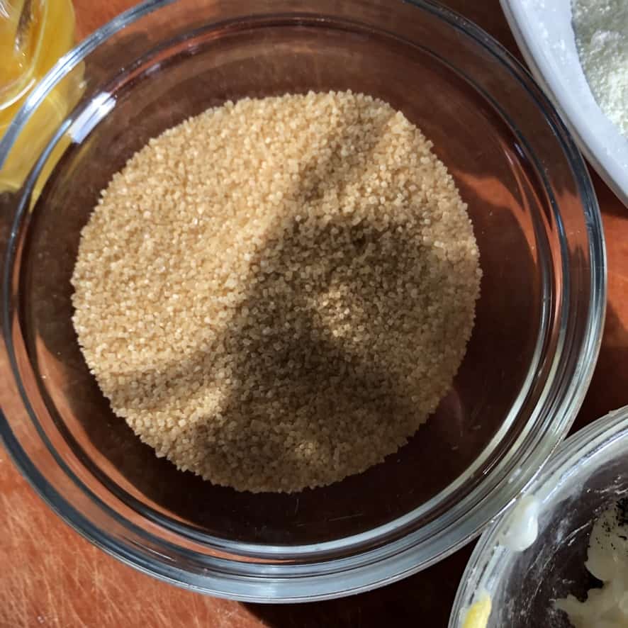 Natural cane sugar in a bowl with a light golden brown color.