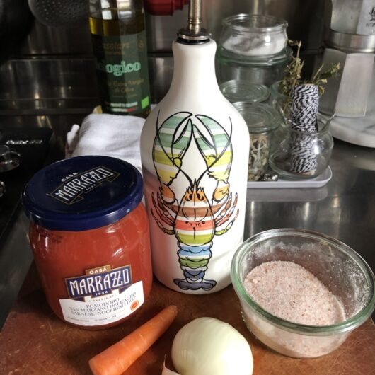 raw tomato pasta sauce ingredients on a cutting board