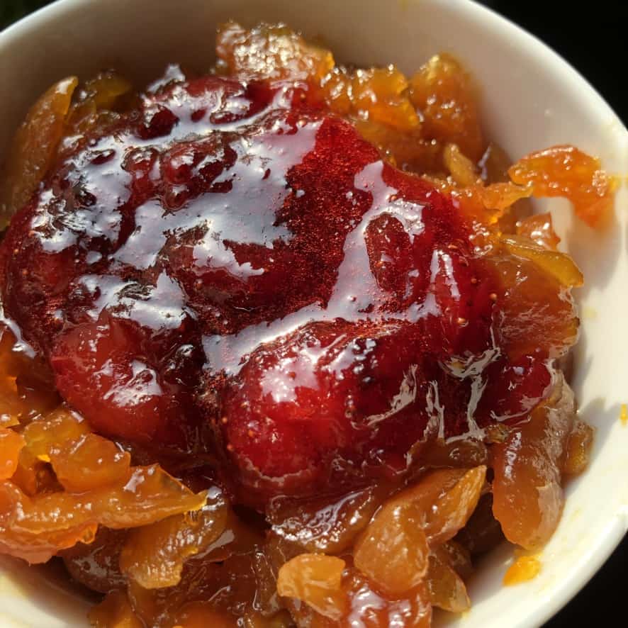 a bowl of homemade candied apricots and strawberries
