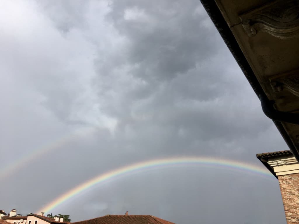 a double rainbow in a very grey sky