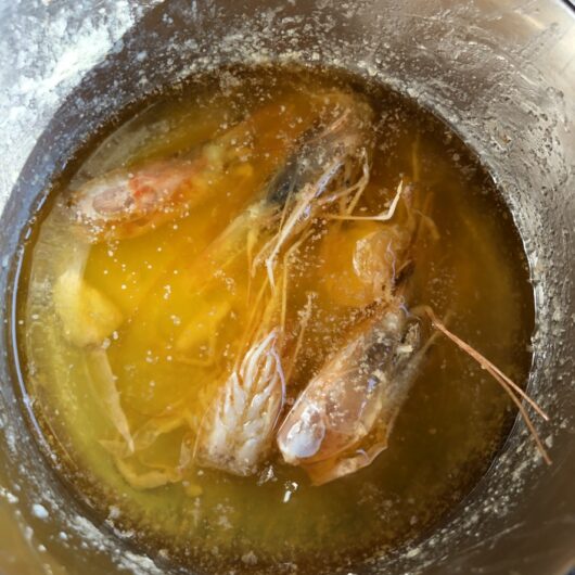 clarified shrimp butter with shrimp heads still in it