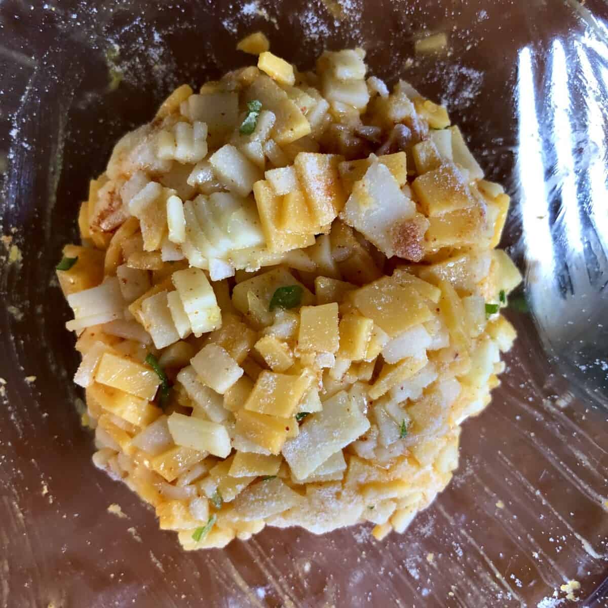 cheddar and provolone diced with scallions and bound with egg yolk and 1/4 teaspoon of flour formed into a round disc shape to put inside the mushroom