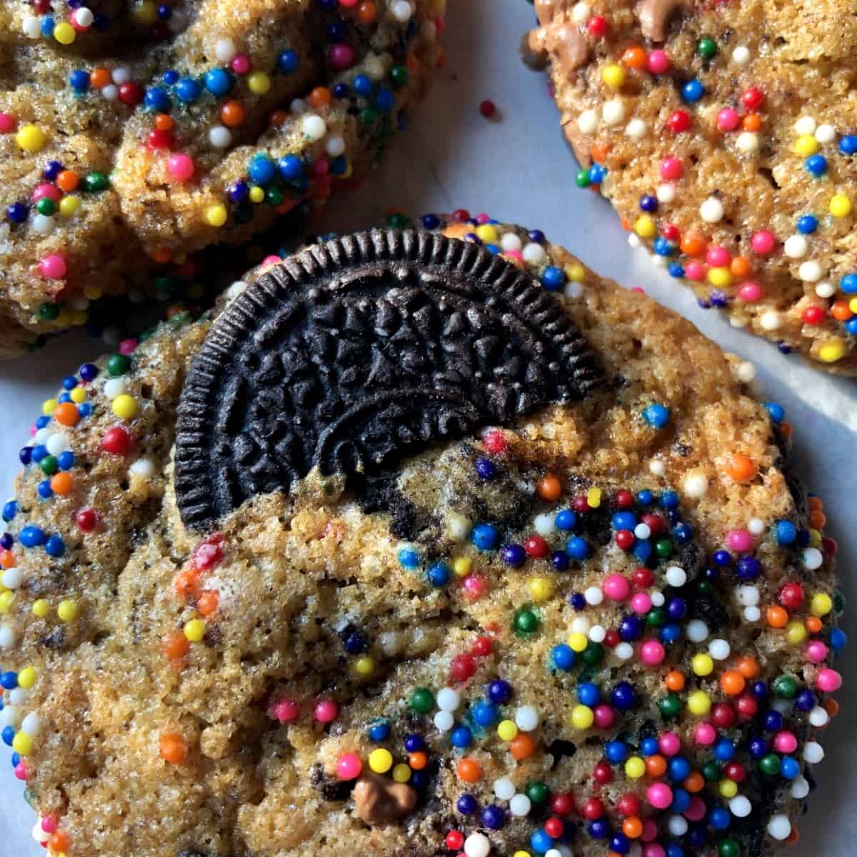 double oreo confetti cookies with halves of oreos in each cooking sticking out in a way that looks like it's in the cookie's back pocket